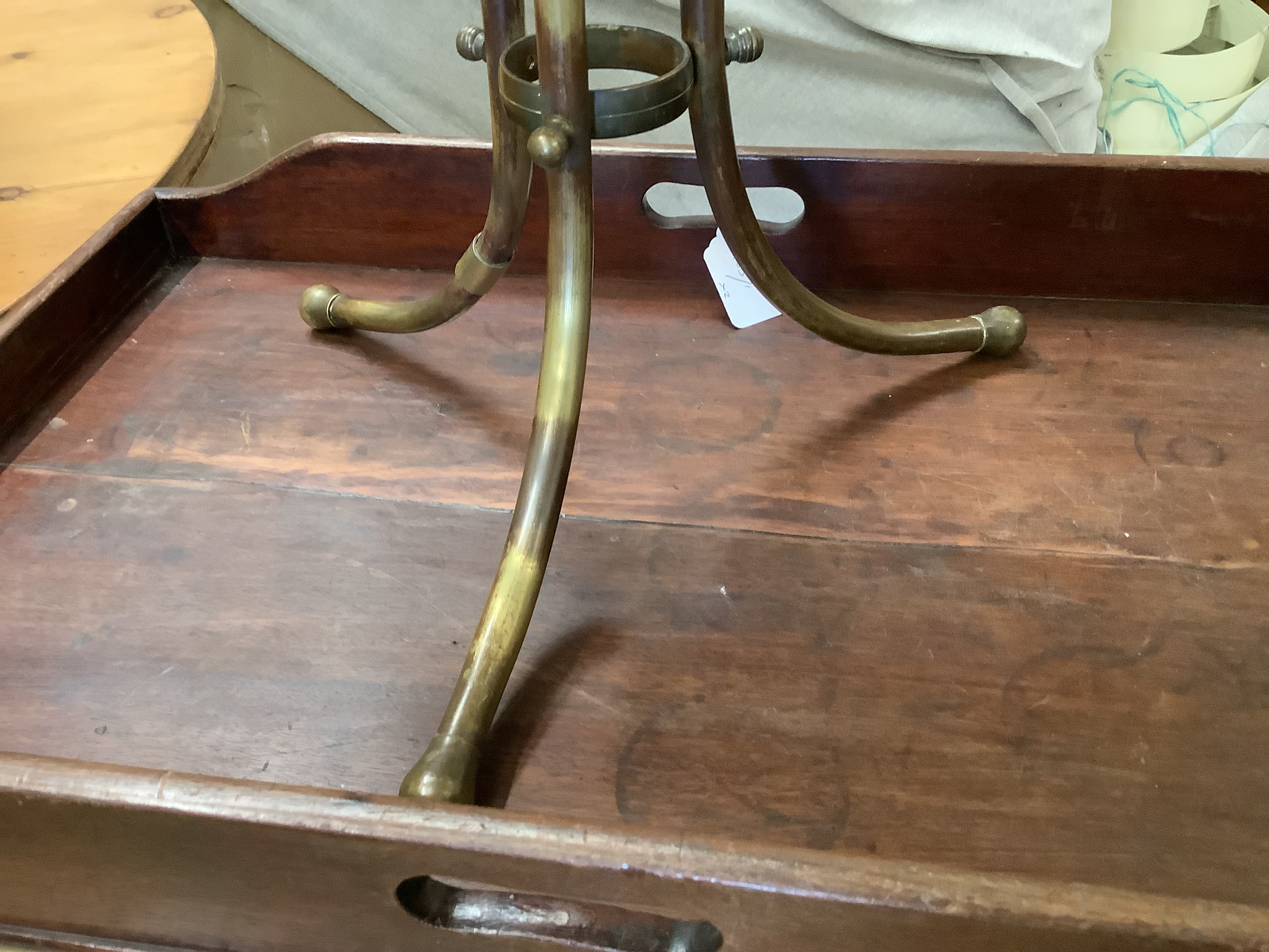 A brass framed tripod magazine stand together with a Victorian mahogany butler's tray, width 67cm, depth 42cm